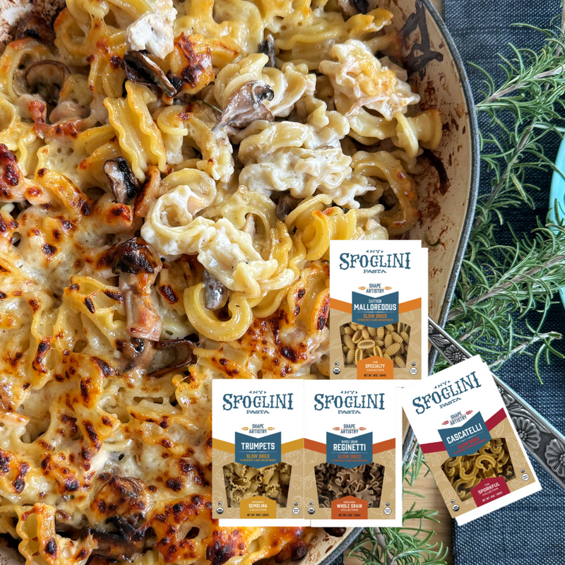 Best of Sfoglini Pasta Sampler - Trumpets, Cascatelli, Whole Grain Reginetti, Saffron Malloreddus pasta boxes on finished pasta dish.