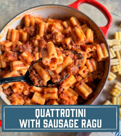 Pasta with sausage ragu in a red pot, with a spoonful of pasta above the pot. With text overlay "Quattrotini with Sausage Ragu"