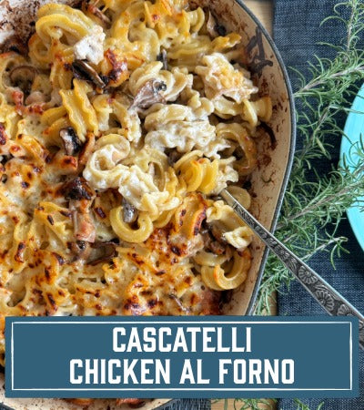 Sfoglini Pasta Recipe: Cascatelli Chicken al Forno in a dish with herbs on a blue napkin. With text overloay - Cascatelli Chicken al Forno