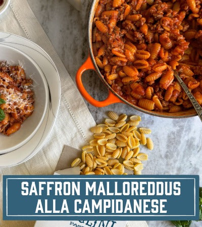 Sfoglini Pasta Recipe: Pasta dish with text 'Saffron Malloreddus alla Campidanese' on a marble surface.