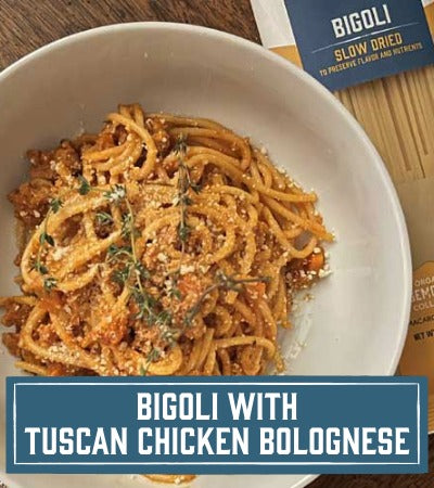 Sfoglini Pasta Recipe: long pasta dish with Tuscan chicken bolognese in a white bowl, featuring Bigoli pasta packaging. with text overlay "Bigoli with Tuscan chicken bolognese"
