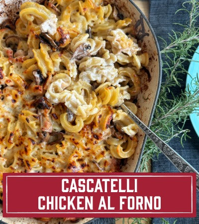 Sfoglini Pasta Recipe: Cascatelli Chicken al Forno in a dish with herbs on a blue napkin. With text overloay - Cascatelli Chicken al Forno