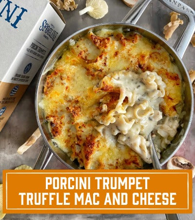 Sfoglini Pasta Recipe: Mac and cheese dish in a pan with porcini trumpet truffle flavor, featuring a brand box in the background. With text overlay "Porcini Trumpet Truffle Mac and Cheese"