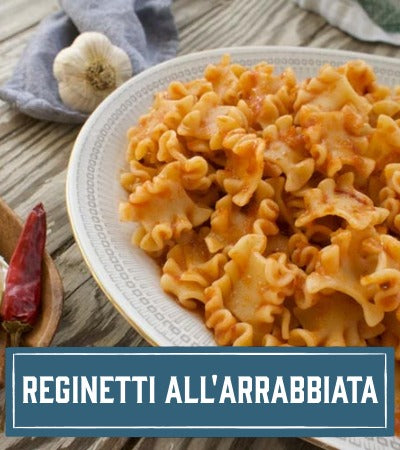 Sfoglini Pasta Recipe: cooked pasta dish  with red sauce with text 'Reginetti all'Arrabbiata' on a wooden table.