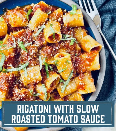 Sfoglini Pasta Recipe: Pasta dish with slow roasted tomato sauce in a blue bowl with a fork, text overlay 'Rigatoni with Slow Roasted Tomato Sauce'.