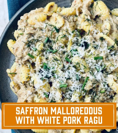 Sfoglini Pasta Recipe: Pasta dish with white pork ragu on a black plate with text overlay "Saffron Malloreddus with White Pork Ragu"
