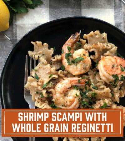 Sfoglini Pasta Recipe: Shrimp Scampi with Whole Grain Reginetti on a black plate with text overlay "Shrimp Scampi with Whole Grain Reginetti "