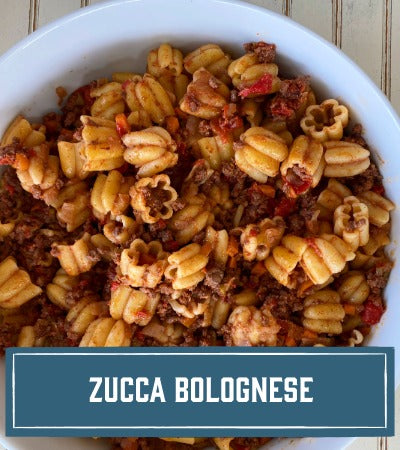Sfoglini Pasta Recipe:  Pasta dish with ground meat and vegetables in a white bowl, labeled 'Zucca Bolognese'.