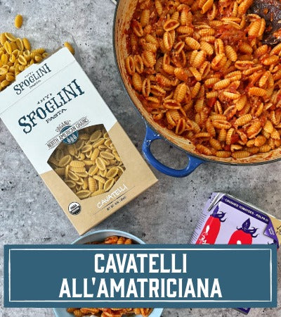 Sfoglini Pasta Recipe: pasta with a box and a pot of cavatelli all'amatriciana on a gray surface. with text overlay "cavatelli all'amatriciana"