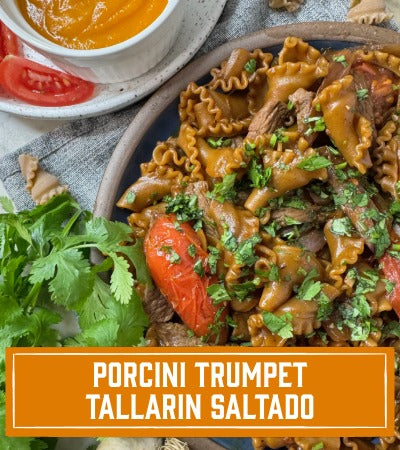 Sfoglini Pasta Recipe: Plated dish of porcini trumpet tallarin saltado with garnishes on a textured surface. with text overlay "porcini trumpet tallarin saltado"