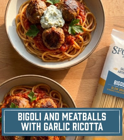 Two bowls of noodles with meatballs and garlic ricotta, next to a package of Bigoli pasta. Recipe: Bigoli and Meatballs with Garlic Ricotta