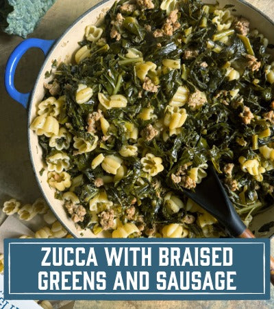 Sfoglini Pasta Recipe: Zucca with Braised Greens and Sausage. Pumpkin shaped pasta with kale and greens in a blue pot