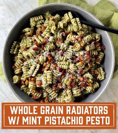 Whole Grain Radiators with Mint Pistachio Pesto. Pasta in bowl with green pesto 